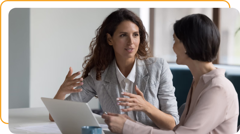two business women with laptop - orange box